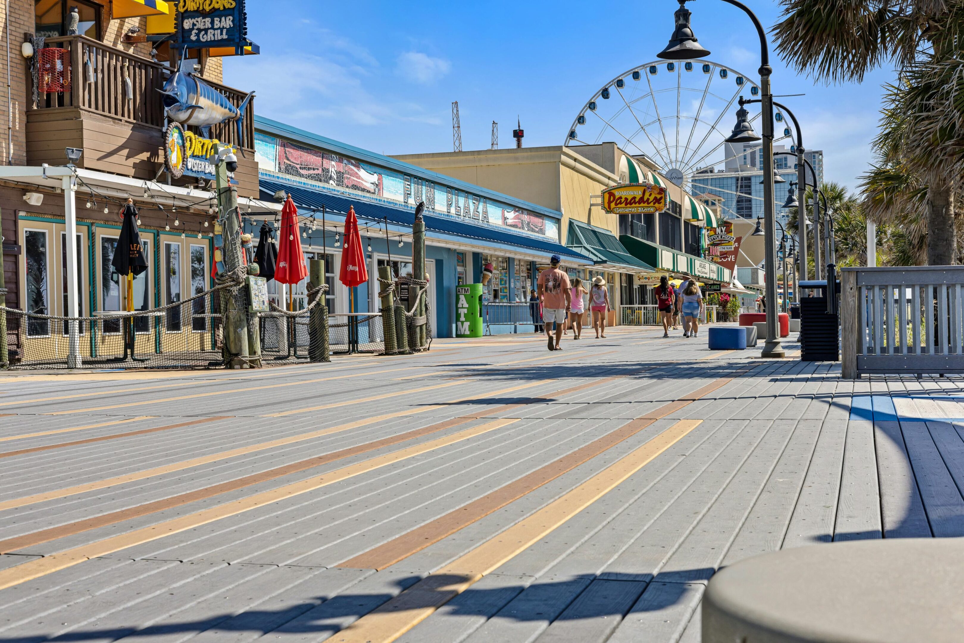 A street with people walking on it and buildings in the background.