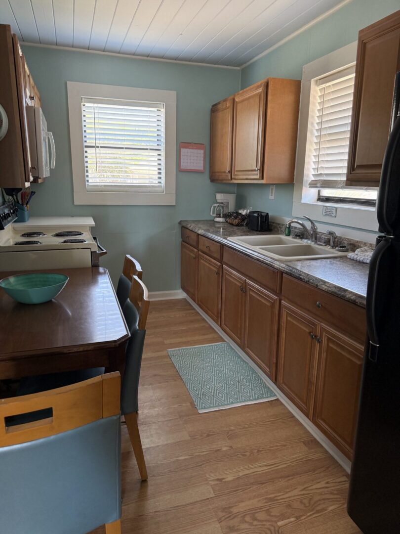 Kitchen with wooden cabinets, sink, and table