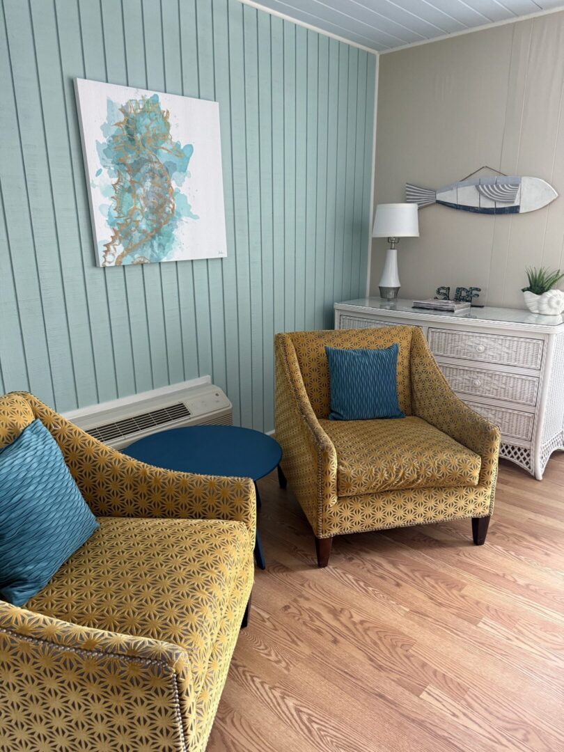 Cozy coastal room with patterned yellow chairs
