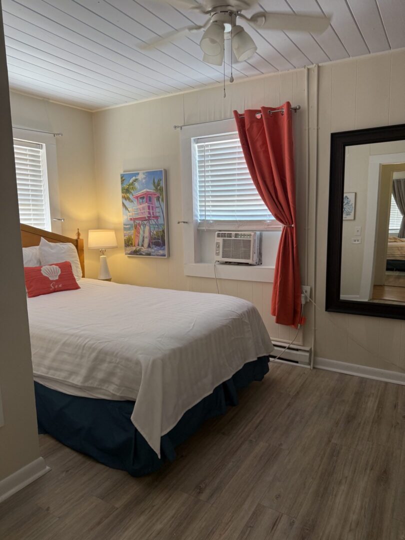 Cozy bedroom with white bed and red curtains