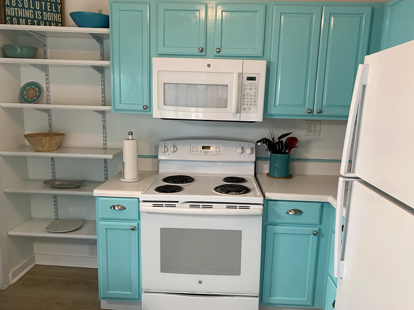 Sea Gables Cottage kitchen with teal cabinets and open shelving