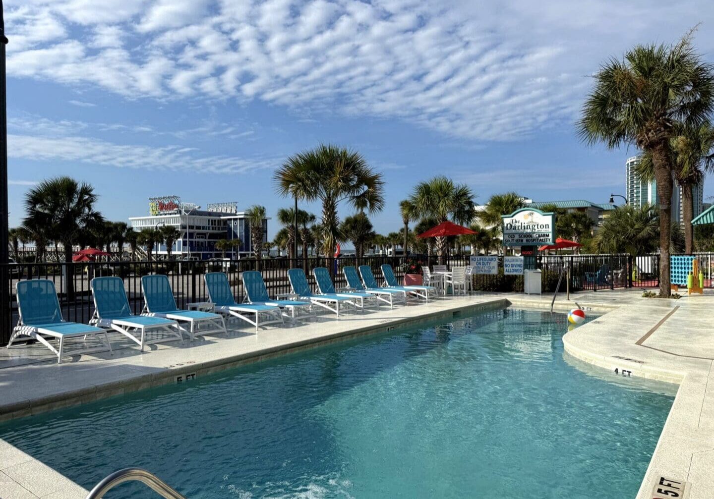 Pool at the Darlington Inn & Cottages with new blue lounge chairs and palm trees